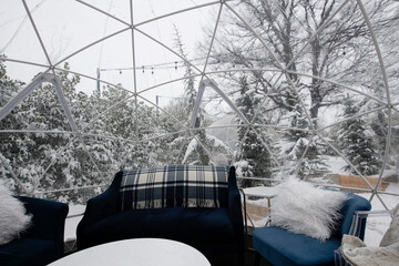 Inside of a decorated igloo tent on a wintery day