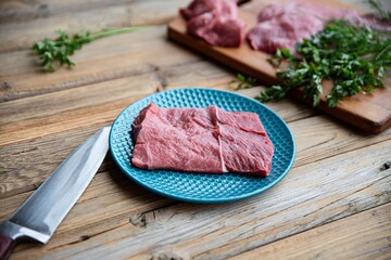 Fresh raw beef on a cutting board. A piece of beef on a plate.
