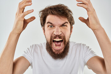 emotional man with a beard gesturing with his hands close-up studio aggression
