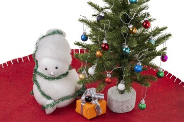 Close up view of christmas decoration objects on red carpet on white wall background. Christmas holiday concept.
