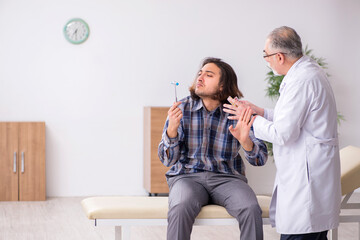 Young male patient visiting experienced doctor neurologist