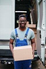 Young Afro-American or African male working in everyday or daily home delivery service.