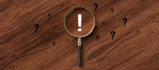 centered magnification glass with an exclamation mark on wooden background
