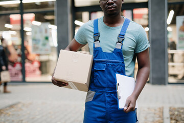 Young Afro-American or African male working in everyday or daily home delivery service.