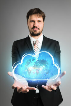 businessman presenting a virtual cloud with a world map in front of grey background