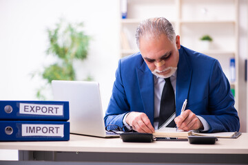 Old face injured employee sitting in the office
