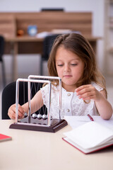 Small girl preparing for exams at home