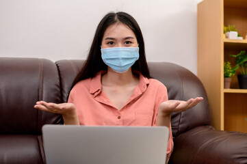 woman in face mask with laptop during Learning at home