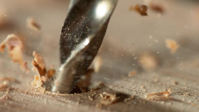Super slow motion of detail of a drill bit drilling into wood. Filmed on high speed cinema camera, 1000 fps.