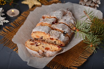 Christmas stollen on white parchment - top view.