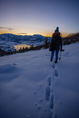 Photographers photographing winter lake mountain scene in sunset, alone in wilderness