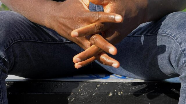 concentration, meditation - black man crosses his hands as if he were praying