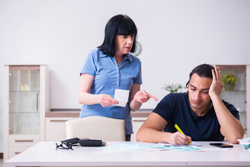 Female pensioner and her young son in budget planning concept