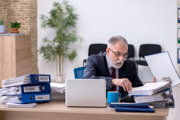 Aged male employee unhappy with excessive work