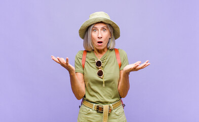 middle age woman feeling extremely shocked and surprised, anxious and panicking, with a stressed...