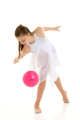 little girl is engaged in fitness with a ball.