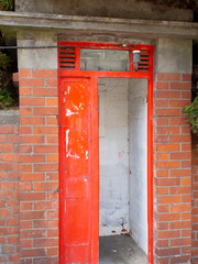 Old Red Phone Booth In A Brick Wall