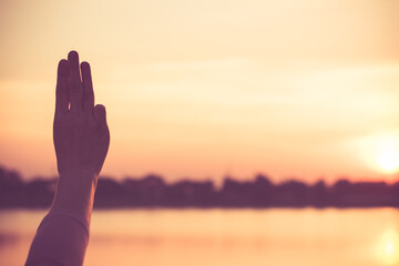 Silhouette close up woman hand holding love in the park.
