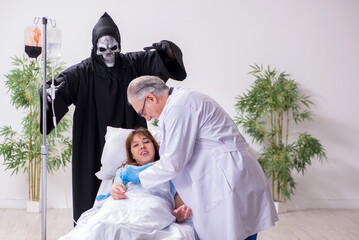 Devil, old doctor and female patient in the clinic