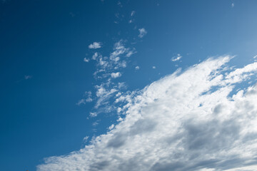 The blue sky background with tiny clouds closeup