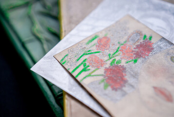 Flower drawing on two books on a table in close up concept.