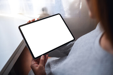 Top view mockup image of a woman holding digital tablet with blank white desktop screen