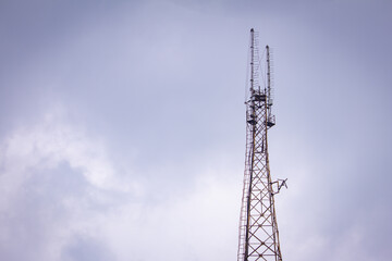 Communication tower with the overcast sky background.