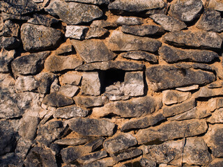 old stone barn in the village in spring