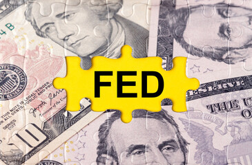 Puzzle with the image of dollars in the center of the inscription -FED