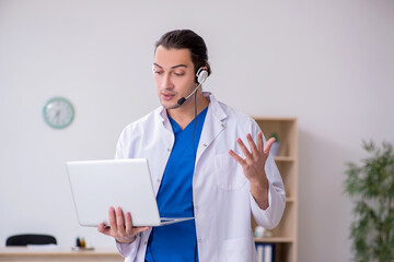 Young male doctor in telemedicine concept