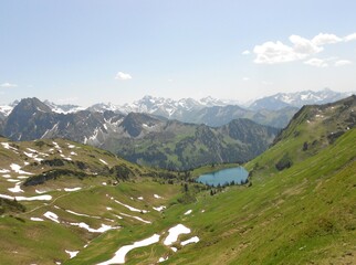 Swiss mountains in the summer, mountain landscape with mountains and clouds and lake