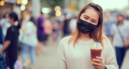 Young woman wearing face mask at Street market in Thailand, travel concept new normal 