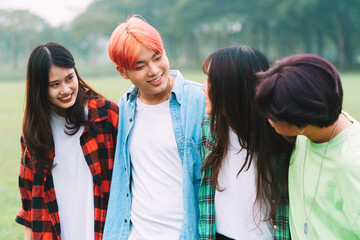 Cheerful Asian people huddling in the park