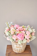 Beautiful flower composition a bouquet in a wicker basket. Floristry concept. Spring colors