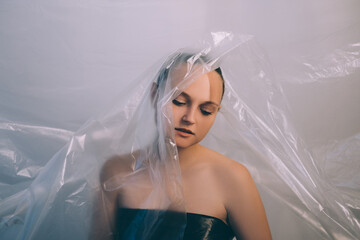 Art portrait. Plastic pollution. Ecology problem. Waste reduction. Tired disappointed pensive woman...