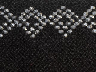 Black knitwear, handmade pattern in detail view