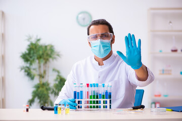Young male chemist working in the lab