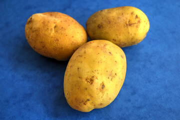 close up of potatoes on blue background