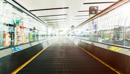 Empty travelator with morning light reflection in the air port terminal. passenger moving walkway. Travel and transportation concepts.