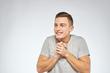 Handsome man in gray t-shirt cropped view of emotion Studio Model