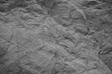 White rock texture. Gray stone background. Grunge background. Rough rocky surface with cracks.