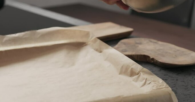 Slow motion making granola, pour on baking sheet