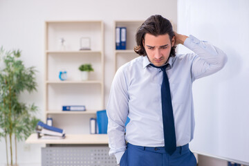 Young man employee in business presentation concept