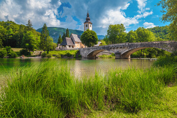 Alpine church and stone bridge over lake Bohinj, Slovenia