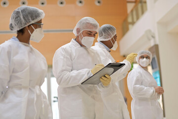 Medical team standing in hospital, getting feedback