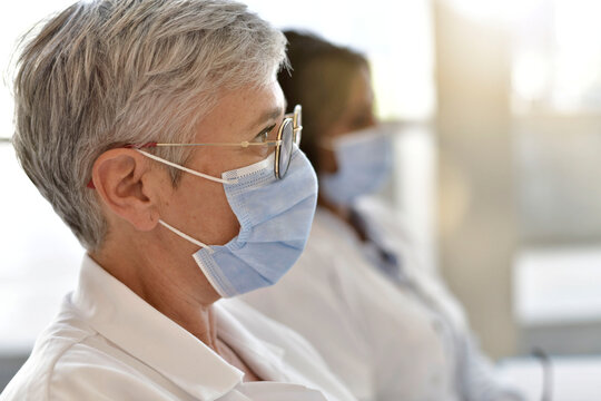 Profile View Of Doctor Woman With Face Mask Attending Conference During 19-ncov Crisis