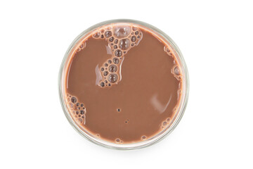 Chocolate milk puddle in glass isolated on white background.