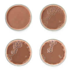 Chocolate milk puddle in glass isolated on white background.