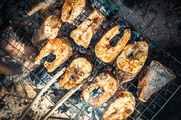 Grilled fish steaks on campfire. Outdoor cooking. Top view