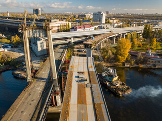 Bridge construction site in Kiev. Sunny autumn morning. Aerial drone view.